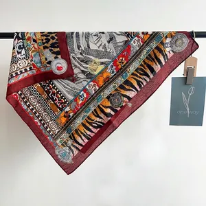 Detailed pattern of a square silk scarf with tiger stripes and ethnic floral motifs