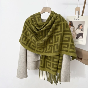 Deep green cashmere feel scarf with geometric patterns and tassel trim for winter elegance