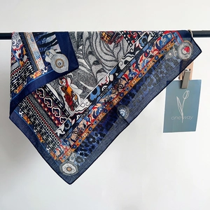 Detailed view of lightweight navy silk scarf with ethnic geometric patterns and floral motifs