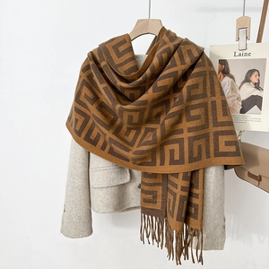 Winter faux cashmere scarf with geometric pattern and tassels on a beige blazer coat