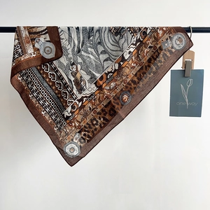 Detailed close-up of leopard print and vintage baroque patterns on silk square scarf