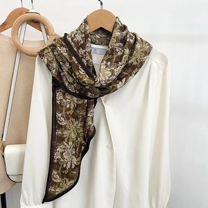 Retro floral print faux silk skinny scarf for women over a white minimalist shirt