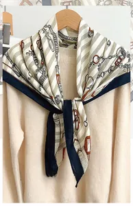 Detail of 90cm herringbone square scarf with chain patterns on a knit sweater