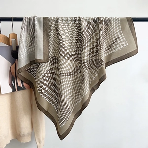 Detail of coffee and cream herringbone houndstooth large square scarf in a soft draped fold