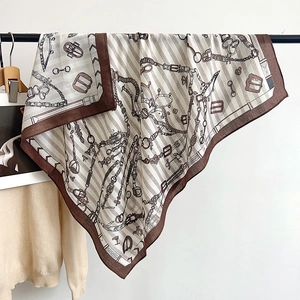Detailed close-up showing the soft silk-like texture and chain belt pattern of the scarf