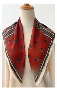 Detail of herringbone silk-feel scarf with retro red pattern and striped border edges