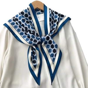 Polka dot vintage silk scarf in navy blue and white, draped elegantly for women