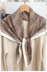 Detailed macro view of 90 series caramel brown herringbone pattern square scarf