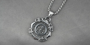 Detail view of retro titanium steel necklace with fleur-de-lis star compass pendant
