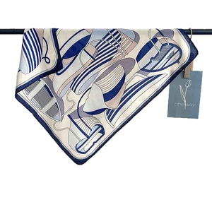 French style square silk scarf with navy blue stripes and nautical abstract pattern on a rack
