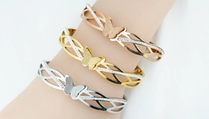 Detailed view of rhinestone butterfly cuff bracelets in gold, silver, and rose gold