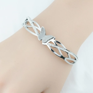 Silver butterfly bracelet with crystal accents and hollow woven band on a female wrist