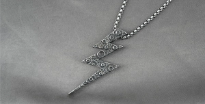 Macro shot of vintage silver lightning pendant with industrial meteorite texture