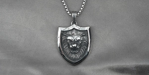 Macro shot of vintage silver lion head shield pendant with antique textures and chain
