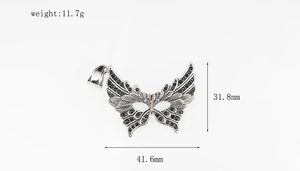 Macro shot of silver mask butterfly pendant with black zircon and exact dimensions