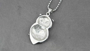 Macro shot of silver pendant back with hammered texture and stainless steel box chain necklace