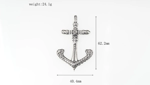 Detail view of steel anchor pendant with skull and cross motifs including size specs
