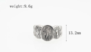 Detailed macro view of retro silver textured ring with vertical bark patterns and wide surface