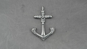 Detailed close-up of a gothic anchor cross pendant with skull and diamond accents