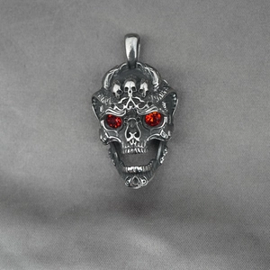 Gothic skull pendant in titanium steel with red rhinestone eyes and horn details
