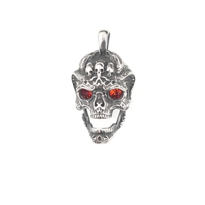 Vintage punk skull pendant in aged steel with red gem eyes and gothic carvings