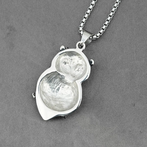 Vintage silver owl necklace pendant with box chain, viewed from a 45-degree angle