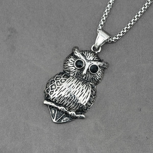 Vintage stainless steel owl pendant with black gem eyes and detailed feather textures