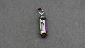 Macro detail of rainbow stainless steel cremation pendant with clear glass window