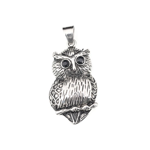 Vintage silver owl pendant necklace with black gemstone eyes and brushed steel texture