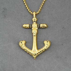 Gold skull anchor pendant necklace with black rhinestones and cross detail on box chain