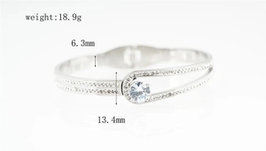 Detailed view of silver titanium steel bangle with belt buckle design and cubic zirconia