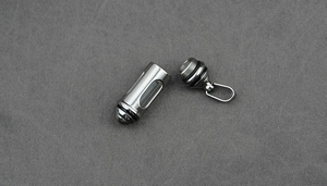 Detail view of a waterproof stainless steel capsule pendant with glass window and screw cap