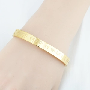 Titanium steel gold-plated bangle with engraved Buddhist mantras and luxury finish