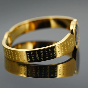 Golden titanium steel bangle with engraved Buddhist scriptures and Bagua motif
