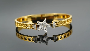 Macro shot of gold-plated titanium star bracelet with shimmering pave-set crystals