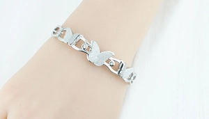Detail of silver butterfly bracelet featuring frosted textures and zircon embellishments