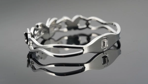 Detailed macro shot of a silver butterfly bracelet with sparkling crystal accents