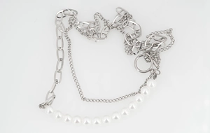 Detail of layered titanium steel chain necklace with white pearls and vintage OT clasp closure