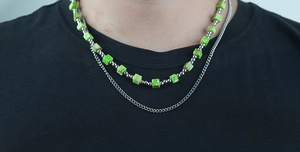 Detail of layered turquoise cube beads and silver ball beads on men's steel necklace