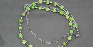 Detail of bohemian turquoise square stone beads and silver metal chain link layering