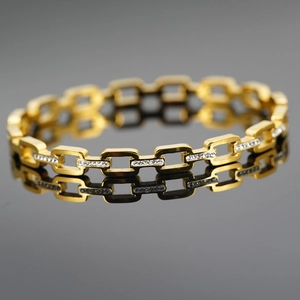 Golden chain link bracelet with woven pattern and sparkling white zircon stones