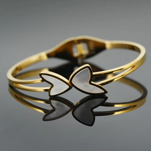 Elegant gold-plated stainless steel bangle with white mother of pearl butterfly wing detail