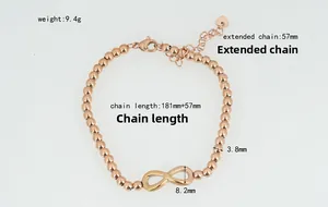 Detail view of rose gold bead bracelet with infinity charm and heart tag dimensions