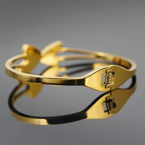 Polished gold stainless steel hollow butterfly bangle with spring pressure buckle
