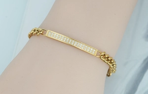 Detail of a gold titanium steel bracelet featuring double-row crystal zircon settings