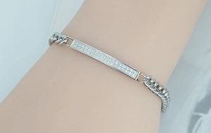 Macro shot of silver titanium steel Cuban chain bracelet with double-row zircon inlay