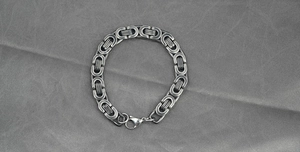 Detailed close-up of antique silver Byzantine chain with a secure lobster clasp