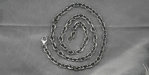 Detailed view of retro industrial style steel cable chain necklace with lobster clasp