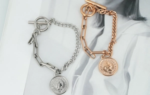 Detail view of titanium steel coin bracelets with OT clasp in silver and rose gold