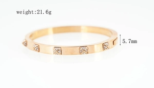 Macro shot of rose gold stainless steel bangle with diamond squares, weighing 21.6g